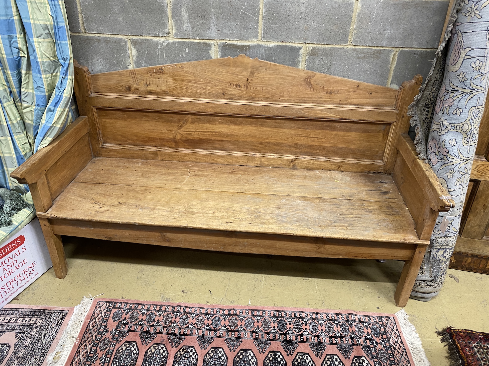 A 19th century Continental fruitwood settle, width 184cm, depth 72cm, height 108cm